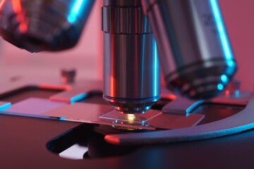 Poster - Toned photo of a backlit microscope lens in a science laboratory