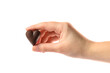© New Africa - Woman holding heart shaped chocolate candy on white background, closeup