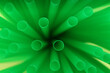 © New Africa - Heap of green plastic straws for drinks, closeup