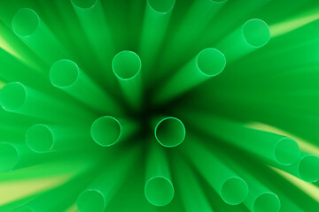 Wall Mural - Heap of green plastic straws for drinks, closeup