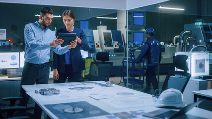 Poster - Factory Office Meeting Room: Male Chief Engineer Holds Digital Tablet Computer, Shares Screen to Female Project Manager, They Talk, Find Optimization Solution. Modern Industry 4.0 CNC Machinery