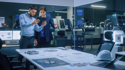 Poster - Factory Office Meeting Room: Male Chief Engineer Holds Digital Tablet Computer, Shows Screen to Female Project Manager, They Talk, Find Optimization Solution. Modern Industry 4.0 CNC Machinery