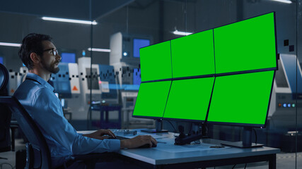 Poster - Industry 4.0 Modern Factory: Security Operator Controls Proper Functioning of Workshop Production Line, Uses Computer with 6 Screens Showing Green Screen Mock up Template.