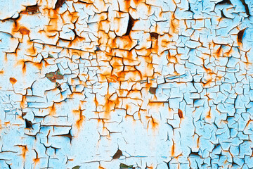 Bright textured weathered grunge background for your design. Rusty metal surface cracked with peeling old blue and red paint.