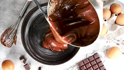 Wall Mural - cooking chocolate cake- pouring chocolate dough in mold