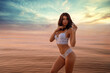 © aleonovs - Young beautiful sexy fit brunette  model pose on the beach in white lingerie on the dramatic sunset