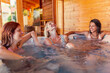 © Impact Photography - Girl friends relaxing in a hot tub while on a vacation