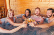 © Impact Photography - Friends relaxing and making a toast in a hot tub while on a vacation