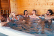 © Impact Photography - Friends relaxing in a hot tub while on a vacation