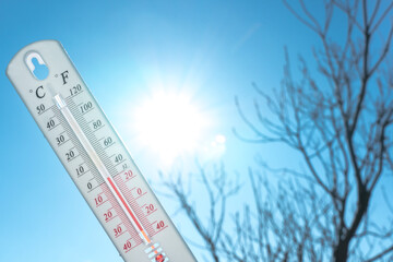 the thermometer lies on the snow and shows a negative temperature in cold weather on the blue sky.me