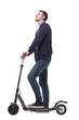 © ASDF - smiling young man with an electric scooter .
