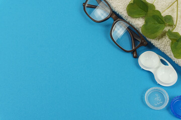 The lens case and glasses are on the blue background on the right