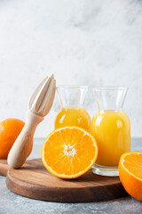 Wall Mural - Glass pitchers of juice with slice of orange fruit