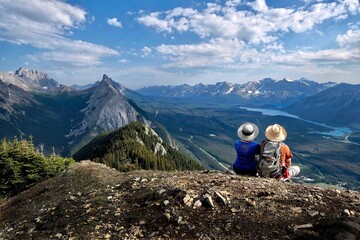 adventurous couple on mountain top looking at scenic view. kananaskis. king's creek ridge. alberta. 