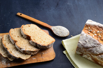 Sliced rye bread on a Board. On a black table. Top view