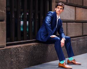 Young Man Relaxing on Street in New York City.