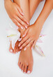 © iordani - manicure pedicure with flower lily closeup isolated on white perfect shape hands spa salon