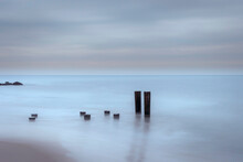 USA, New Jersey, Cape May National Seashore. Beach Pilings On Stormy Sunrise.