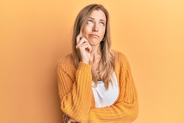 Canvas Print - Beautiful caucasian woman wearing casual clothes thinking concentrated about doubt with finger on chin and looking up wondering