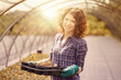 © Stocked House Studio - happy female workers trimming plants in greenhouse