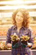 © Stocked House Studio - happy female workers trimming plants in greenhouse