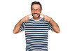 © Krakenimages.com - Middle age man wearing casual clothes and glasses smiling cheerful showing and pointing with fingers teeth and mouth. dental health concept.