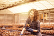 © Stocked House Studio - happy female workers trimming plants in greenhouse