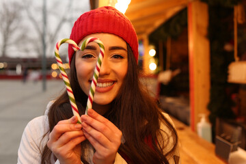 Wall Mural - Young woman spending time at Christmas fair