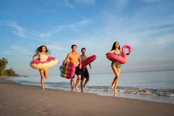  Holiday summer party with friends on the beach .Group of family and friends  jumping on the beach. lifestyle people vacation holiday on beach