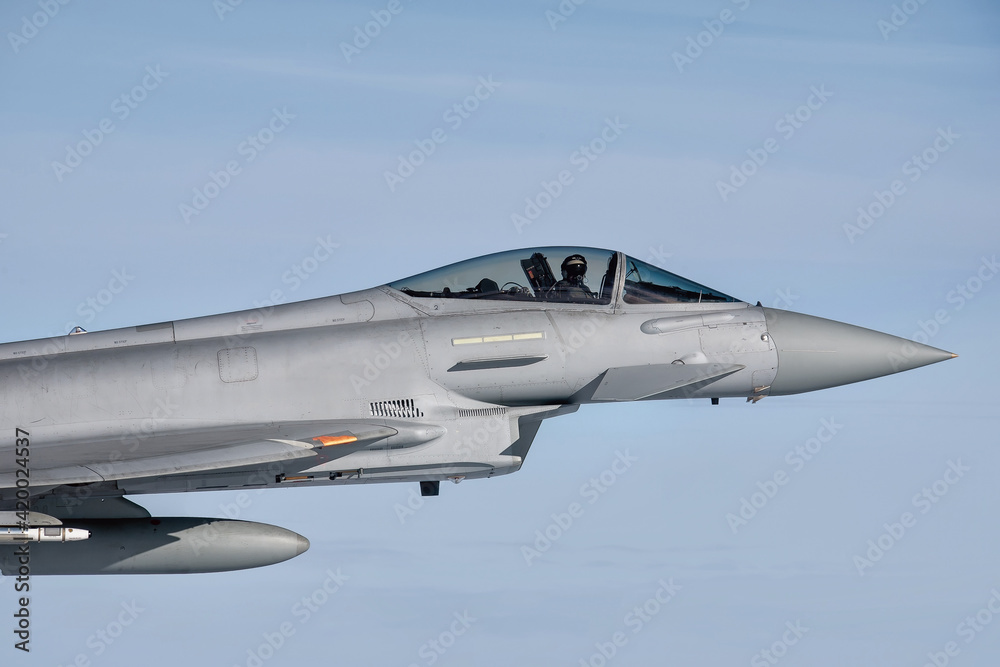 Royal Air Force Typhoon Fighter Jet. Supersonic interceptor  flying in formation high above the clouds on a combat mission.