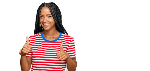 Beautiful hispanic woman wearing casual clothes success sign doing positive gesture with hand, thumbs up smiling and happy. cheerful expression and winner gesture.