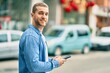 © Krakenimages.com - Young caucasian man smiling happy using smartphone at the city.