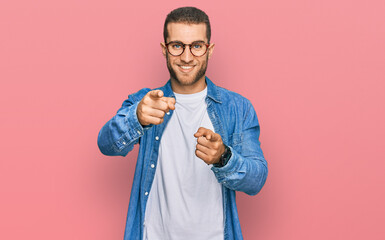 Wall Mural - Young caucasian man wearing casual clothes pointing fingers to camera with happy and funny face. good energy and vibes.