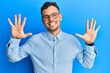 © Krakenimages.com - Young hispanic man wearing casual clothes and glasses showing and pointing up with fingers number ten while smiling confident and happy.