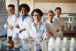 © luckybusiness - Group of young laboratory technicians