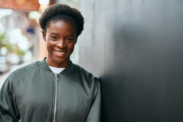 Poster - Young african american girl smiling happy standing at the city.