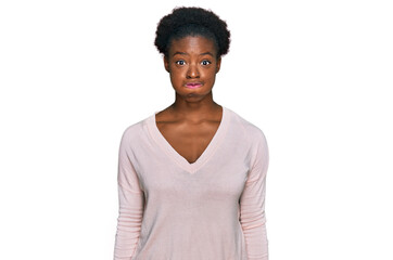 Poster - Young african american girl wearing casual clothes puffing cheeks with funny face. mouth inflated with air, crazy expression.