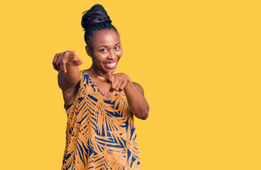 Canvas Print - Young african american woman wearing casual clothes pointing to you and the camera with fingers, smiling positive and cheerful