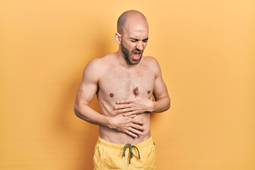 Sticker - Young bald man wearing swimwear with hand on stomach because nausea, painful disease feeling unwell. ache concept.