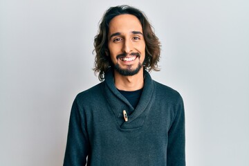 Young hispanic man wearing casual clothes with a happy and cool smile on face. lucky person.