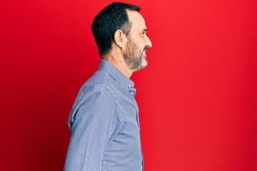 Poster - Middle age hispanic man wearing casual clothes looking to side, relax profile pose with natural face with confident smile.