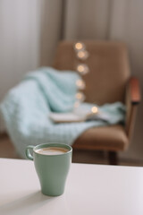 Wall Mural - Cozy home interior with cup of coffee, book and armchair