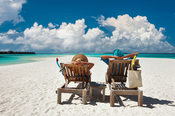 Wall Mural - Couple relax on a beach at Maldives