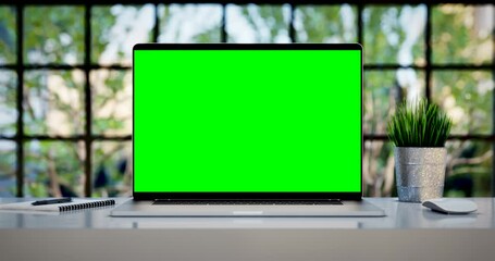 Poster - Laptop with blank green screen. Zoom in footage with trees swaying or moving in the wind. Home interior or loft office background, 4k 24fps UHD