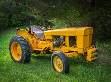 Very Old Yellow Tractor In The Yard Of My Father-in-law's House In Broome County In Upstate NY.  What May Be An Antique Tractor Still Runs And Works The Fields On This Family Farm.  