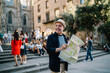 © BullRun - Happy Caucasian man 60s enjoying solo trip vacations for exploring Italy during retirement, cheerful male tourist in straw hat using paper orientation map for walking around historis center
