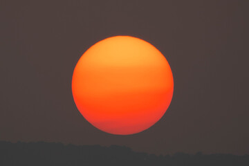 Wall Mural - sunset on sky dark background, big sun golden color on dusk twilight evening wallpaper, beautiful ab
