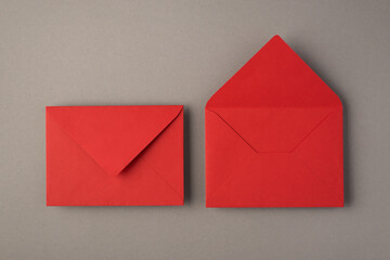 above photo of two bright red envelopes isolated on the grey background