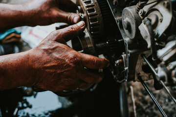 Motorcycle mechanics are assembling the motorcycle engine clutch assembly and maintenance.