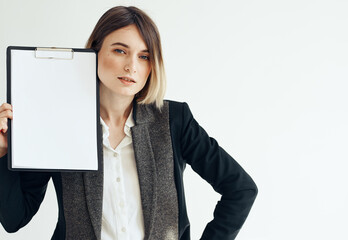 Beautiful woman in jacket with dad documents white sheet of paper mockup